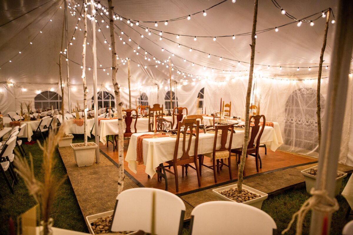 A,Wedding,Venue,Tent,With,Dinner,Equipment,On,Tables,And