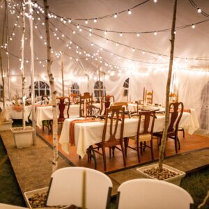 A,Wedding,Venue,Tent,With,Dinner,Equipment,On,Tables,And