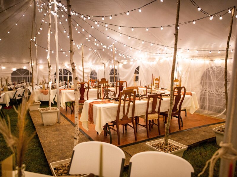 A,Wedding,Venue,Tent,With,Dinner,Equipment,On,Tables,And