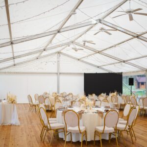 Wedding,Marquee,With,Round,Tables,,Chairs,And,Decor,In,Light